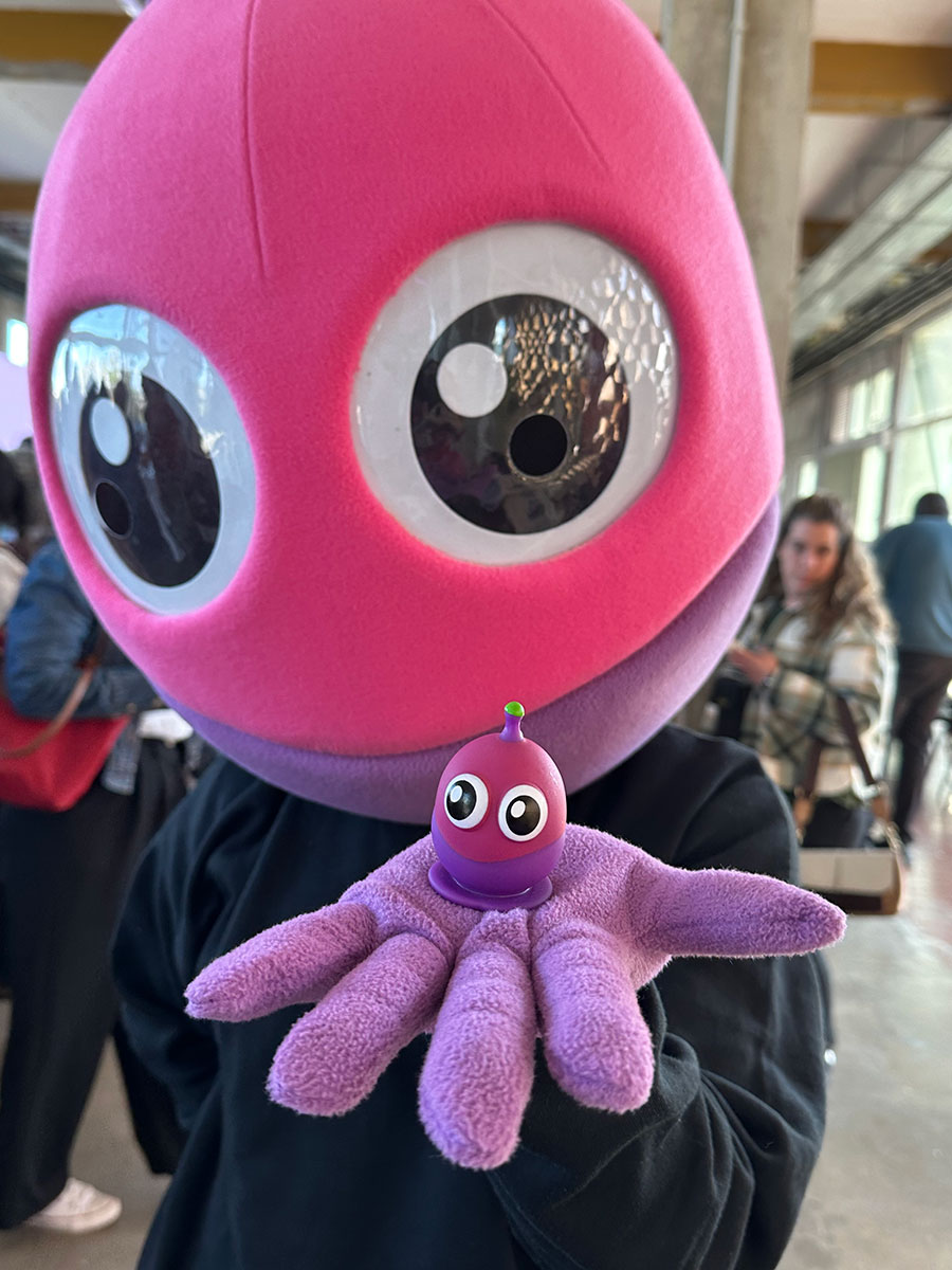 You see a person masquerading as a magic firefly. The character has the open hand where the magic firefly doll is, which appears in shades of purple and violet.