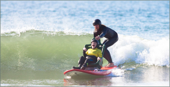 Adapted surfboard with a practitioner and his instructor