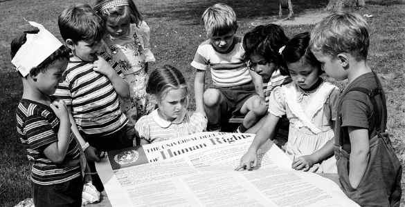 Foto neutra de crianças de várias nacionalidades segurar a declaração universal dos direitos humanos